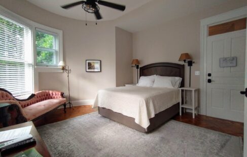 Queen bed, nightstand, fainting couch, rounded walls