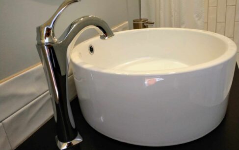 Round vessel sink with faucet